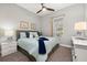 Comfortable bedroom with a queen bed, gray headboard, and white dresser at 2051 Flora Pass Pl, Kissimmee, FL 34747
