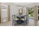 Light-filled dining area featuring a square table with six chairs and access to backyard at 2051 Flora Pass Pl, Kissimmee, FL 34747