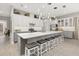 Spacious kitchen with large island, white cabinets, and gray countertops at 2051 Flora Pass Pl, Kissimmee, FL 34747
