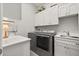 Bright laundry room with washer, dryer, and utility sink at 2051 Flora Pass Pl, Kissimmee, FL 34747