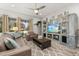 Relaxing living room featuring a brown leather sofa, coffee table, and a large TV at 2051 Flora Pass Pl, Kissimmee, FL 34747