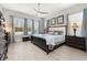 Spacious main bedroom with king-size bed, ample natural light, and two nightstands at 2051 Flora Pass Pl, Kissimmee, FL 34747