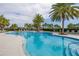 Inviting community pool with lounge chairs and palm trees at 2051 Flora Pass Pl, Kissimmee, FL 34747