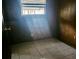 Small bedroom with wood paneling and tile floor at 215 4Th St, Orlando, FL 32824