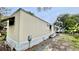 Single-wide mobile home with a beige exterior and small yard at 215 4Th St, Orlando, FL 32824