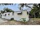 Tan mobile home with mature trees and a small yard at 215 4Th St, Orlando, FL 32824