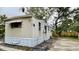 Tan mobile home with mature trees and a fenced backyard at 215 4Th St, Orlando, FL 32824