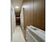 Long hallway with wood paneling and tile floor at 215 4Th St, Orlando, FL 32824