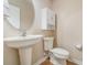 Clean and modern half bathroom with pedestal sink and white toilet at 2226 Seven Oaks Dr, St Cloud, FL 34772