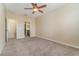 Large bedroom with carpet flooring, ceiling fan, and access to bathroom at 2226 Seven Oaks Dr, St Cloud, FL 34772