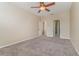 Bright bedroom with carpet flooring, ceiling fan, and access to bathroom at 2226 Seven Oaks Dr, St Cloud, FL 34772