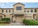 Charming two-story townhome with attached garage, lush landscaping, and a welcoming gated entrance at 2226 Seven Oaks Dr, St Cloud, FL 34772