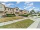 Front view of townhome showcasing landscaping and driveway at 2226 Seven Oaks Dr, St Cloud, FL 34772