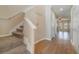 Carpeted staircase and wood flooring in the hallway at 2226 Seven Oaks Dr, St Cloud, FL 34772