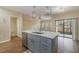 Modern kitchen with island, stainless steel appliances, and light gray cabinets at 2226 Seven Oaks Dr, St Cloud, FL 34772