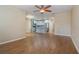 Living room with kitchen view, wood flooring, and ceiling fan at 2226 Seven Oaks Dr, St Cloud, FL 34772