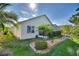 Landscaped backyard with screened porch and palm trees at 224 Fitzgerald Ln, Davenport, FL 33837