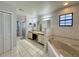 Main bathroom with double vanity and corner tub at 2260 Spring Lake Cir, St Cloud, FL 34771