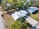 Aerial view of the property showing a metal roof, long driveway, and green lawn at 2601 16Th St, St Cloud, FL 34769