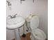 Simple bathroom with pedestal sink and toilet at 2601 16Th St, St Cloud, FL 34769