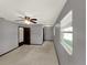 Bright carpeted bedroom with ceiling fan, closet, and window at 2601 16Th St, St Cloud, FL 34769