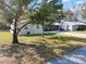 Well-kept home with a metal roof, manicured lawn, and a screened porch at 2601 16Th St, St Cloud, FL 34769