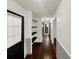 Hallway featuring hardwood floors, floating shelving, and fresh white paint at 2601 16Th St, St Cloud, FL 34769