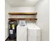 Laundry room with side by side washer/dryer, water heater and storage shelves at 2601 16Th St, St Cloud, FL 34769