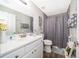 Clean bathroom with white vanity and gray shower curtain at 3 Pecan Drive Loop, Ocala, FL 34472