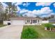 Single-story home with a white garage door and landscaped yard at 3 Pecan Drive Loop, Ocala, FL 34472
