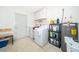 Convenient laundry room with washer, dryer, and storage shelves at 3 Pecan Drive Loop, Ocala, FL 34472