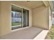 Covered back patio with sliding glass doors leading to a fenced-in yard at 3004 Lady Mae Ln, Kissimmee, FL 34744