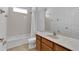 Clean bathroom with tub, toilet and wood vanity at 3004 Lady Mae Ln, Kissimmee, FL 34744