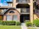 Charming condo building featuring brick facade, yellow siding, and private balconies at 345 Forestway Cir # 106, Altamonte Springs, FL 32701