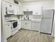 Modern kitchen with white cabinets, stainless steel appliances, and tile backsplash at 345 Forestway Cir # 106, Altamonte Springs, FL 32701