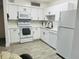 Bright kitchen features white cabinetry, modern appliances, and stylish backsplash at 345 Forestway Cir # 106, Altamonte Springs, FL 32701