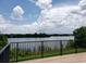 Scenic lake view from a deck with black metal railing and wooded shoreline at 345 Forestway Cir # 106, Altamonte Springs, FL 32701