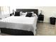 The main bedroom has a large comfortable bed, side tables with lamps, and tile flooring at 345 Forestway Cir # 106, Altamonte Springs, FL 32701