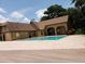 Community pool with poolside deck and building with brown roof at 345 Forestway Cir # 106, Altamonte Springs, FL 32701