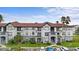 Two-story condo building with attractive exterior and landscaping at 3701 Castle Pines Ln # 3927, Orlando, FL 32839