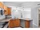 Modern kitchen featuring granite countertops, stainless steel appliances, and wood cabinets at 3701 Castle Pines Ln # 3927, Orlando, FL 32839