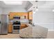 Modern kitchen featuring stainless steel appliances, granite counters and tiled floor at 3701 Castle Pines Ln # 3927, Orlando, FL 32839