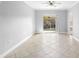 Spacious living area with tile flooring and access to a private balcony at 3701 Castle Pines Ln # 3927, Orlando, FL 32839