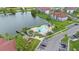 Aerial shot of a community pool area surrounded by palm trees and overlooking a serene lake at 3701 Castle Pines Ln # 3927, Orlando, FL 32839