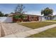 Side view of a house with a brick driveway and a white fence at 413 Egan Dr, Orlando, FL 32822