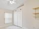 Bedroom with double door closet, window, and wood-look tile floor at 4525 Oakbrook Ct, Kissimmee, FL 34746