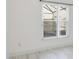 Bedroom with large windows offering pool view and wood-look tile floor at 4525 Oakbrook Ct, Kissimmee, FL 34746