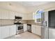 Modern kitchen with white cabinets and granite countertops at 4525 Oakbrook Ct, Kissimmee, FL 34746