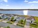 Community of homes near a lake with lush landscaping and palm trees at 4540 Sequel Rd, Kissimmee, FL 34746