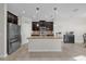 Open kitchen with island, stainless steel appliances and view into living room at 4540 Sequel Rd, Kissimmee, FL 34746